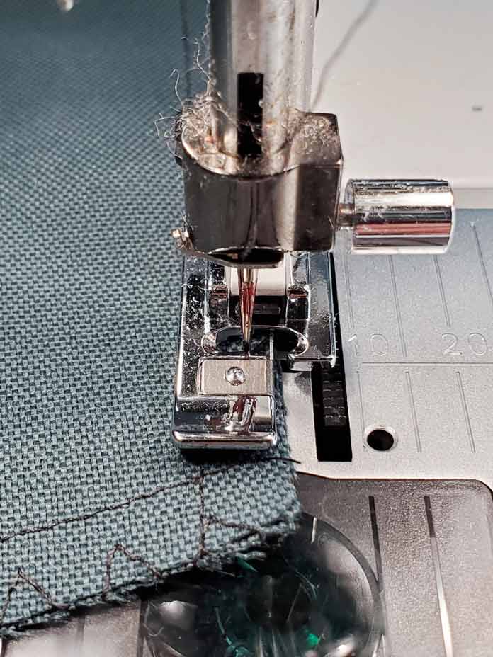 A metal foot on a sewing machine used to overcast raw seam edges. Husqvarna Viking Designer Sapphire 85, Inspira EZ Snip Curved Scissors