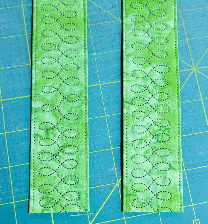 Green curvy stitching on green fabric; Husqvarna Viking Designer Ruby 90 sewing and embroidery machine, Singer 20 Garment Steam Press