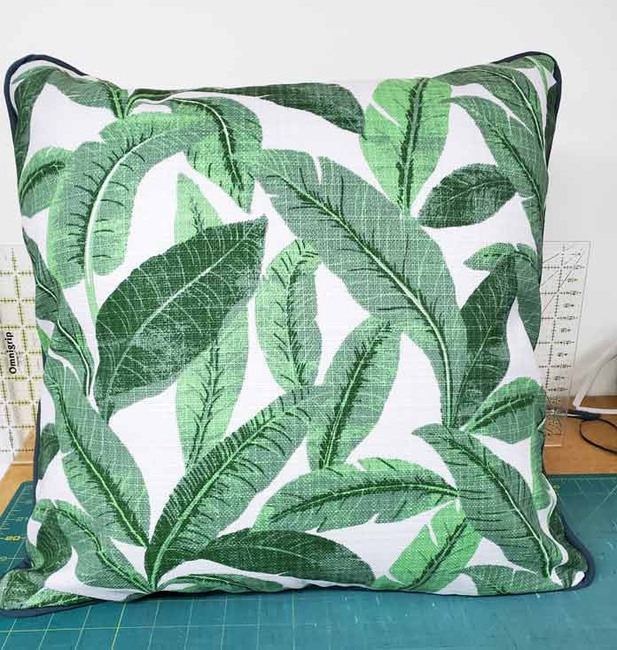A green and white floral cushion cover with green piping; Husqvarna Viking Designer Sapphire 85