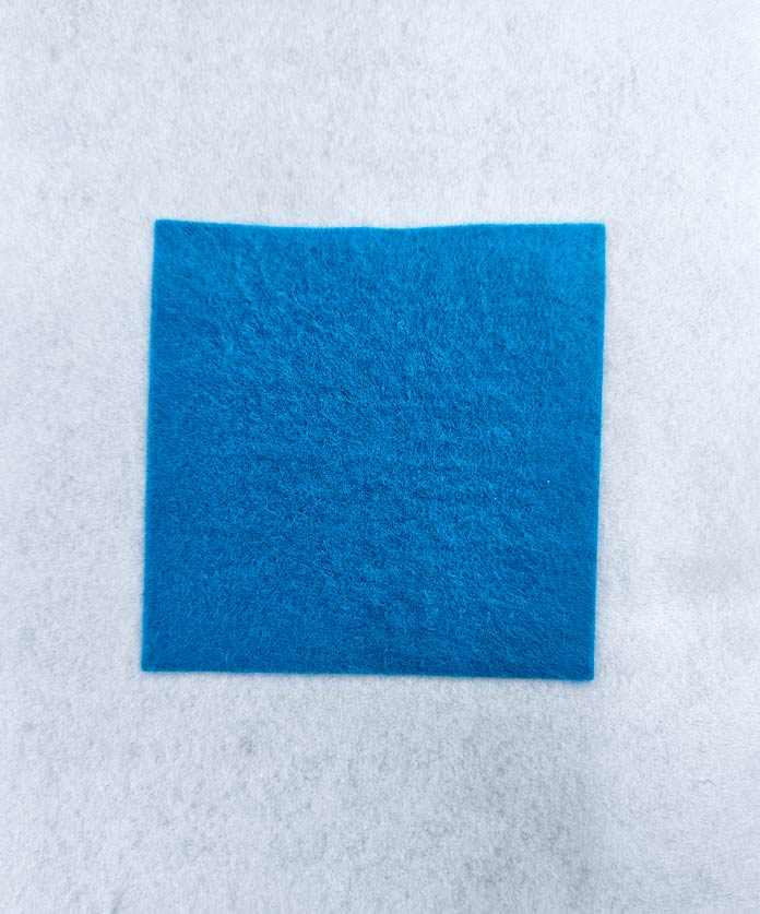 A blue square on white fabric; HeatnBond FeatherLite, fabric samples, fusible web, sewing projects