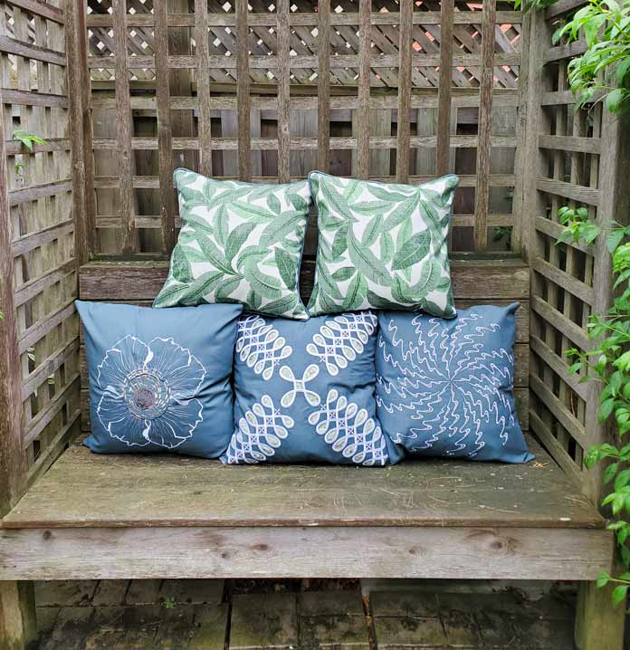 Five green and white cushion covers on a bench; Husqvarna Viking Designer Sapphire 85
