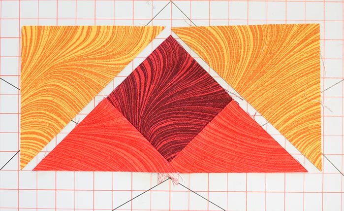 Place a Fabric D triangle on each of the two short sides of each BCB triangle unit. Block 8 in the Spectrum QAL 2020 quilt design features fabrics selected from the Benartex Wave Texture collection.
