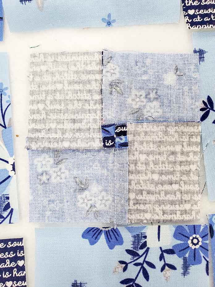 A twirled seam allowance on the back of Block 4 featuring fabric from the Blue Stitch collection by Riley Blake Designs.