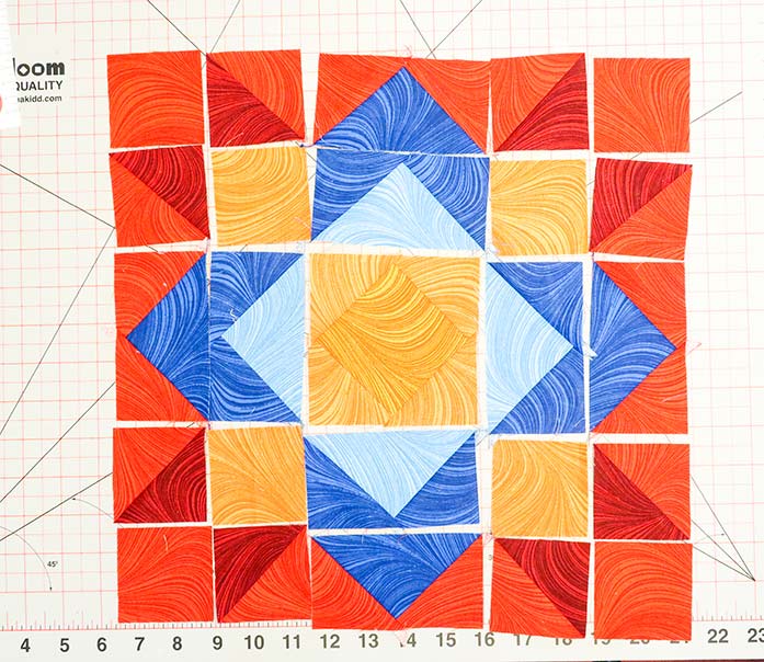 Laying out the fabric units according to the block’s design layout diagram first will make it easier to sew the block’s pieces together correctly. Spectrum QAL 2020 Block 9, Wave Texture collection by Benartex.