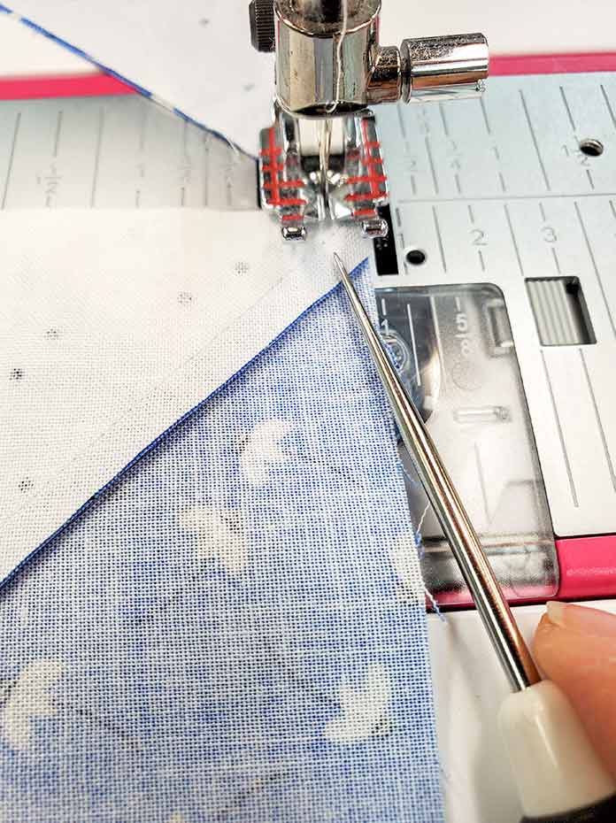 Using a quilter's awl to assist the sewing machine with the lumpy seam allowance. Block 4 featuring fabric from the Blue Stitch collection by Riley Blake Designs.