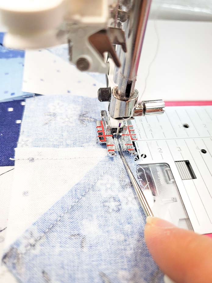 Using a quilter's stiletto to secure the nested seams while sewing. Block 10 of the Spectrum QAL 2020 made with the Blue Stitch collection by Riley Blake Designs.