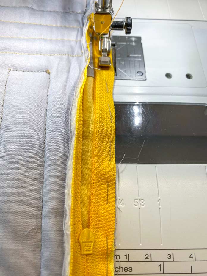 Machine sewing the yellow zipper to the unfinished quilted pencil case; COSTUMAKERS General Purpose Closed End Zipper