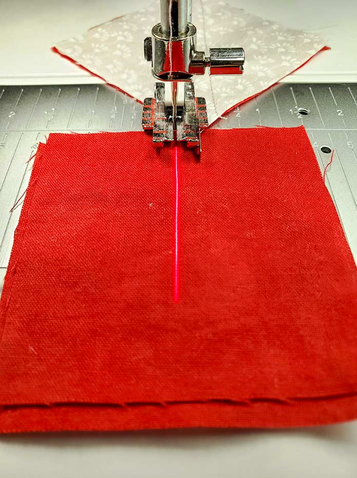The Adjustable Laser Guidance System appears on a red fabric. Husqvarna Viking EPIC 95Q