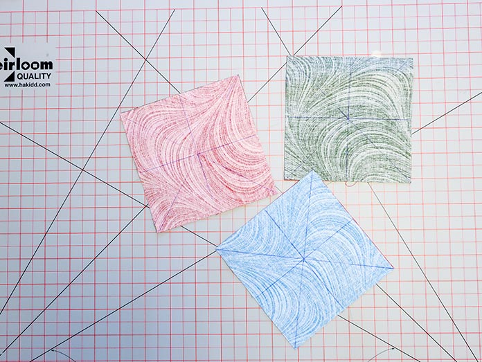 Drawing diagonal lines from corner to corner along with a horizontal and vertical line from edge to edge on the wrong side of one of the pieces in each fabric pair will help you to construct HSTs quickly. Block 5 in the Spectrum QAL 2020 features fabrics from the Wave Texture collection by Benartex.