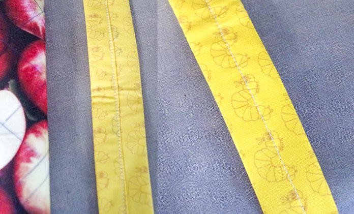 The straps are pictured showing the seam that is sewn down the middle to hold the straps together. The seam is shown from the top and bottom side of the strap – the top side does not show the edge of the fabric that was turned under to hide the raw edge of the seam (it is on the right). The back of the strap shows how the raw edge was turned under and then the seam was sewn to hold the strap together. 