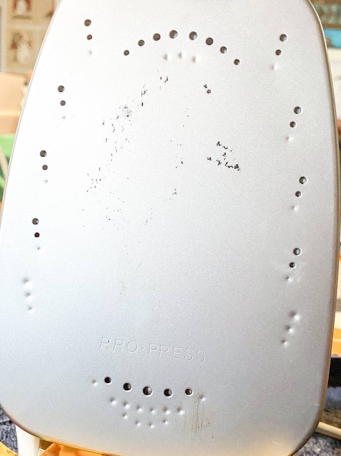 Most of the stains and adhesive on the sole-plate of the Oliso PRO™ TG1600 Smart Iron have been removed by the UNIQUE Home Iron Sole-Plate Cleaner.