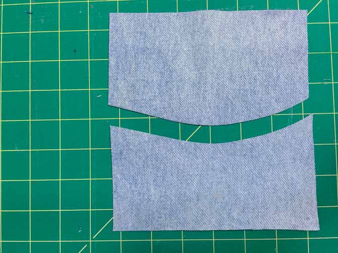 Cut a denim square in half with a gentle wave shape.