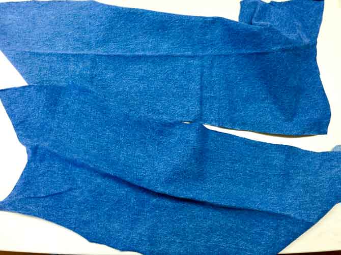 Pieces of denim ready to be cut into quilt blocks.