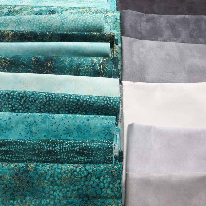 Northcott's Artisan Spirit Shimmer and Artisan Spirit Echoes in the Peacock colorway and Toscana fabrics in gray.