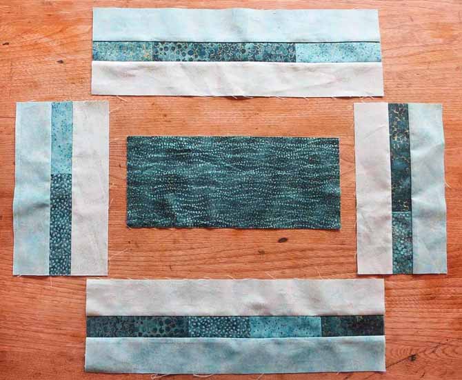 The pieced borders made from the Northcott Artisan Spirit fabrics are ready to be sewn to the center section of the placemat.
