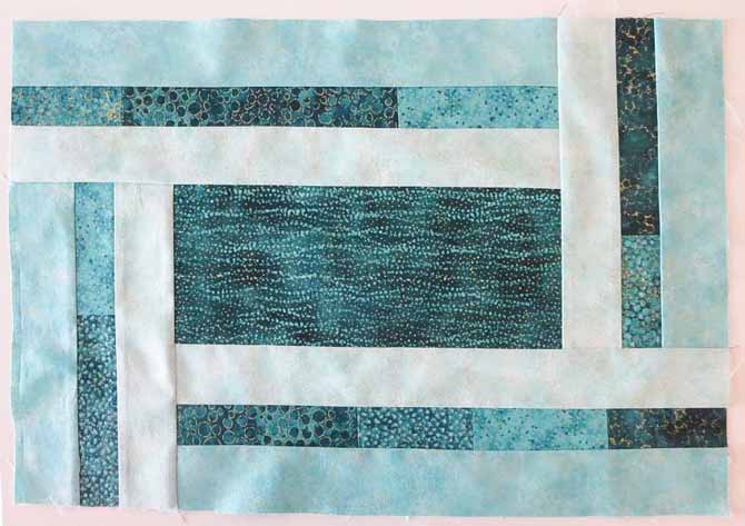 All of the borders on the placemat made with Northcott's Artisan Spirit fabrics have been sewn on.
