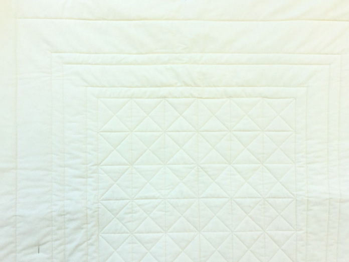 Outline stitched borders give the impression of ditch quilting.