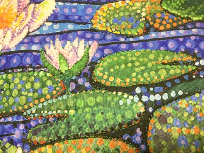 The lily pads on the Artisan Spirit Water Garden panel have been outline quilted with green Sulky rayon thread   SULKY / SCHMETZ / Northcott