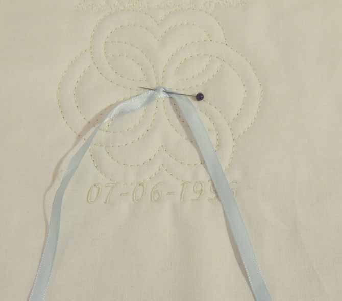 pin and stitch ribbon in place on pillow