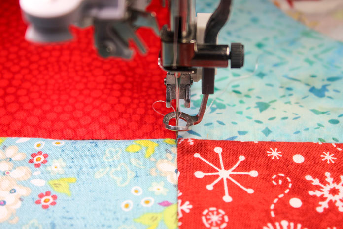 Precise positioning the needle with the quilt in place in the hoop