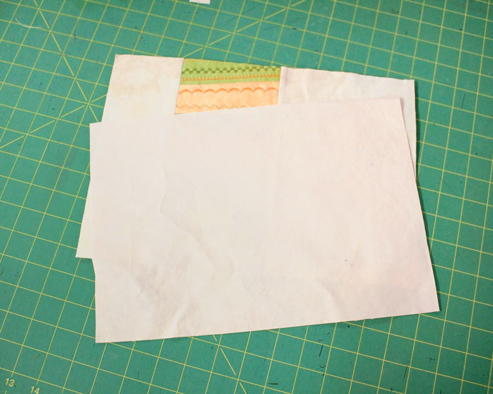 The first step to finishing the placemat is to trim backing and placemat top to the same size.