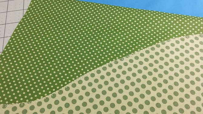 I decided to use a machine blanket stitch to stitch along the landscape applique on both ends of my spring table runner; don't you think that both of these green fabrics from Northcott Fabric's Urban Elementz Basix Collection look great as landscape fabrics?