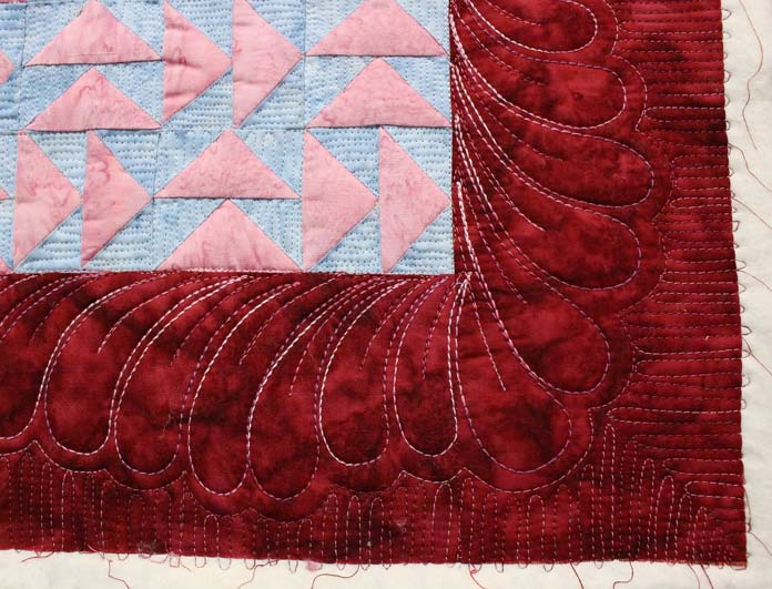 Quilting inside the feathers with finer thread adds more visual interest and texture.