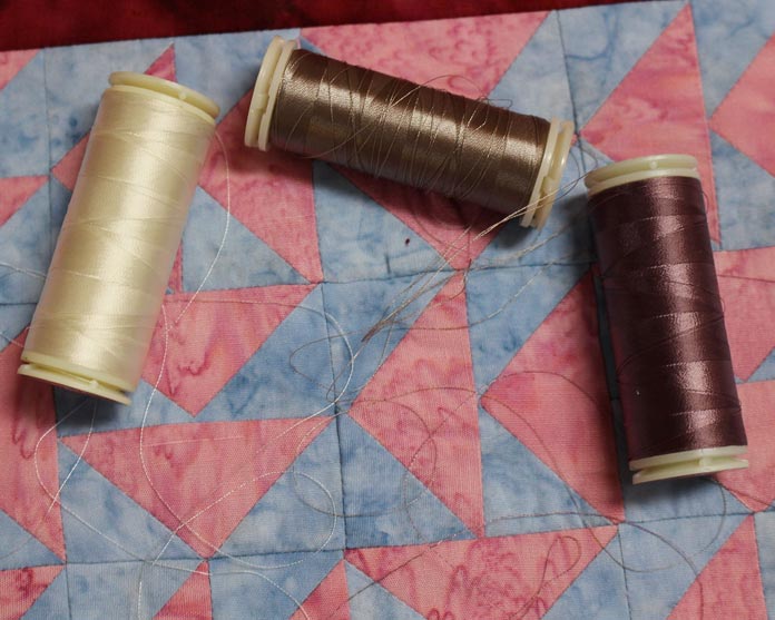 A selection of WonderFil InvisaFil thread to use for quilting.