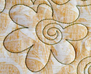 Rounded flower with spiral center machine quilting design
