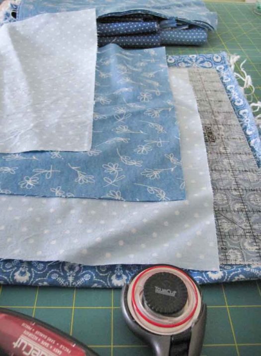 Use a 12½" square ruler to cut several blocks of coordinating background fabrics -- in this case -- breezy casual chambray.