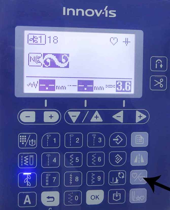 When you touch the single/repeat sewing button on the NQ900 (indicated by the arrow), you get just one stitch pattern. The single stitch is also shown on the LCD screen.