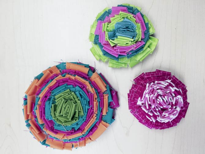 Fabric flowers made from strips of fabric.