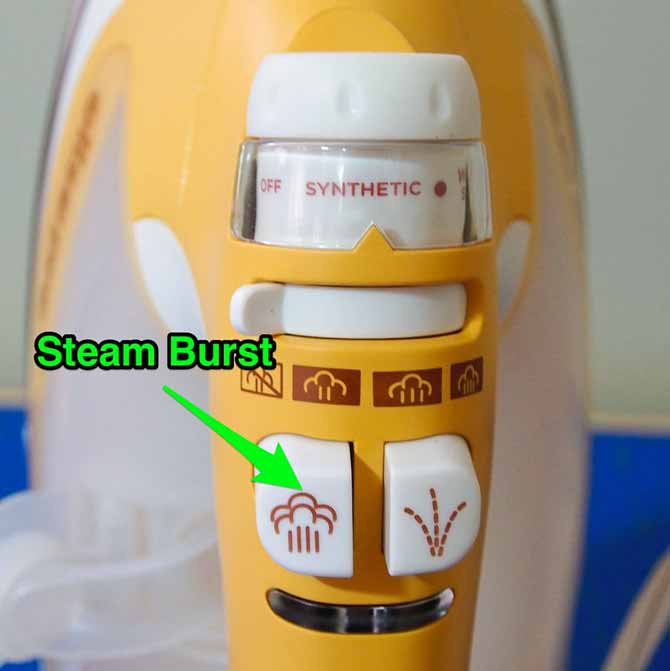 Arrow pointing to burst of steam button on iron handle