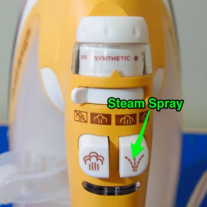 Arrow pointing to button to get a spray of steam for stubborn creases and wrinkles