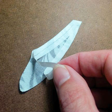 Remove the paper backing from the fusible web