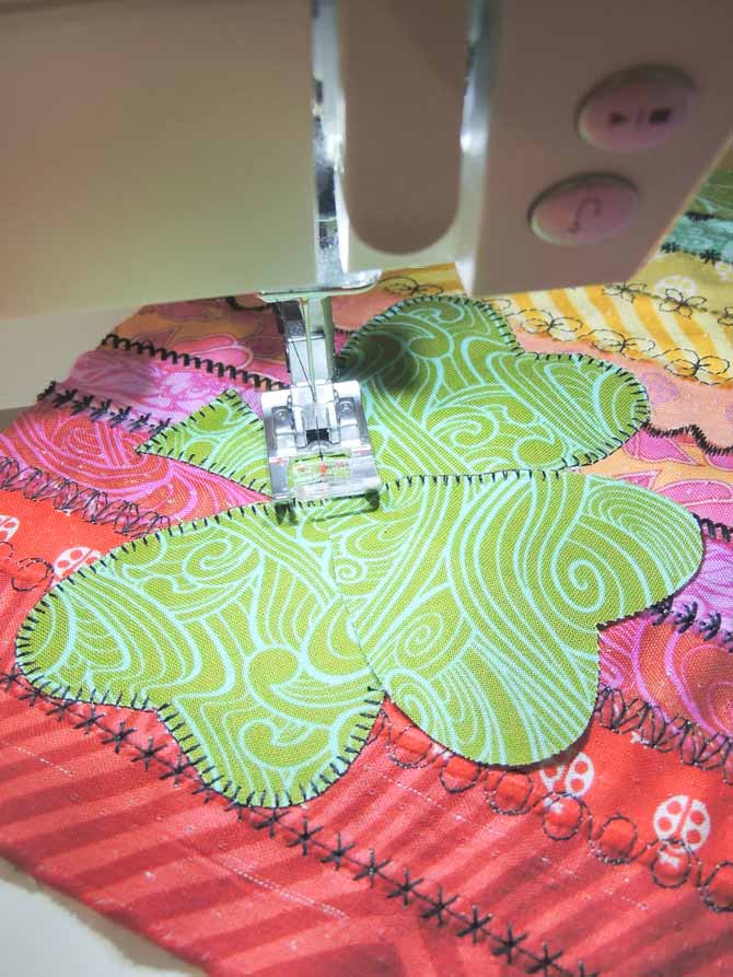The machine blanket stitch on the passport 3.0 is used to applique the shamrock to the stitch sampler.
