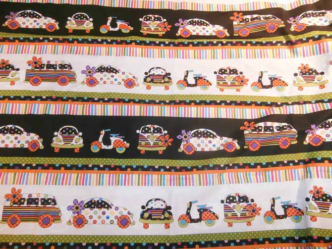 Border fabric that includes strips of vehicles, strips of dots, and strips of stripes. Northcott Urban Elementz.
