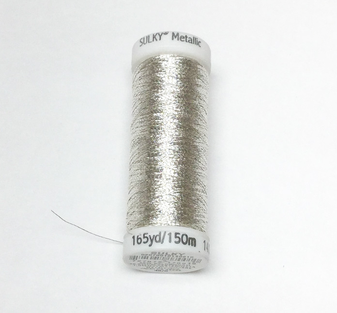 A spool of silver Sulky metallic thread Sulky
