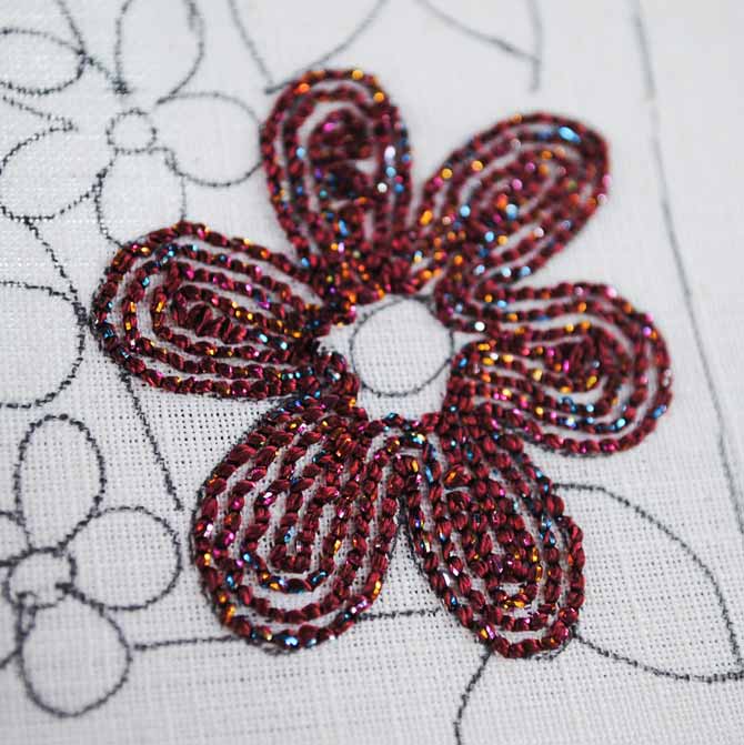 The back of the punchneedle piece shows how the lines of stitching done with the Dazzle thread from WonderFil are placed a needle's width apart.