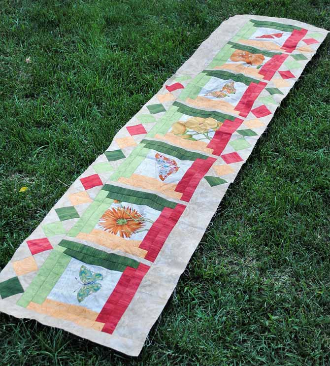 Here is the finished top for the bed runner stretched out on the lawn