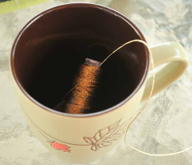 Since we are using the Dazzle thread on a spool, it helps to put the spool in a mug to keep it from rolling away during stitching.