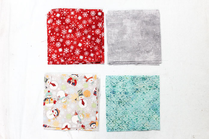 Pick four different fabrics and cut three 6" squares.