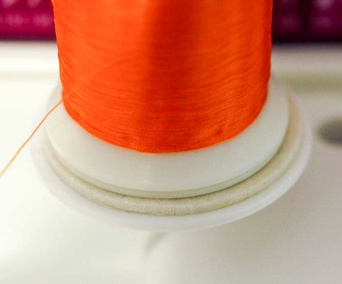 Close up of felt pad between spool and cap