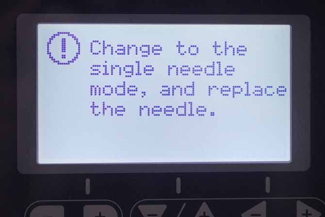 The warning that shows on the LCD screen of the NQ900 when the stitch selected is not compatible with the twin needle.